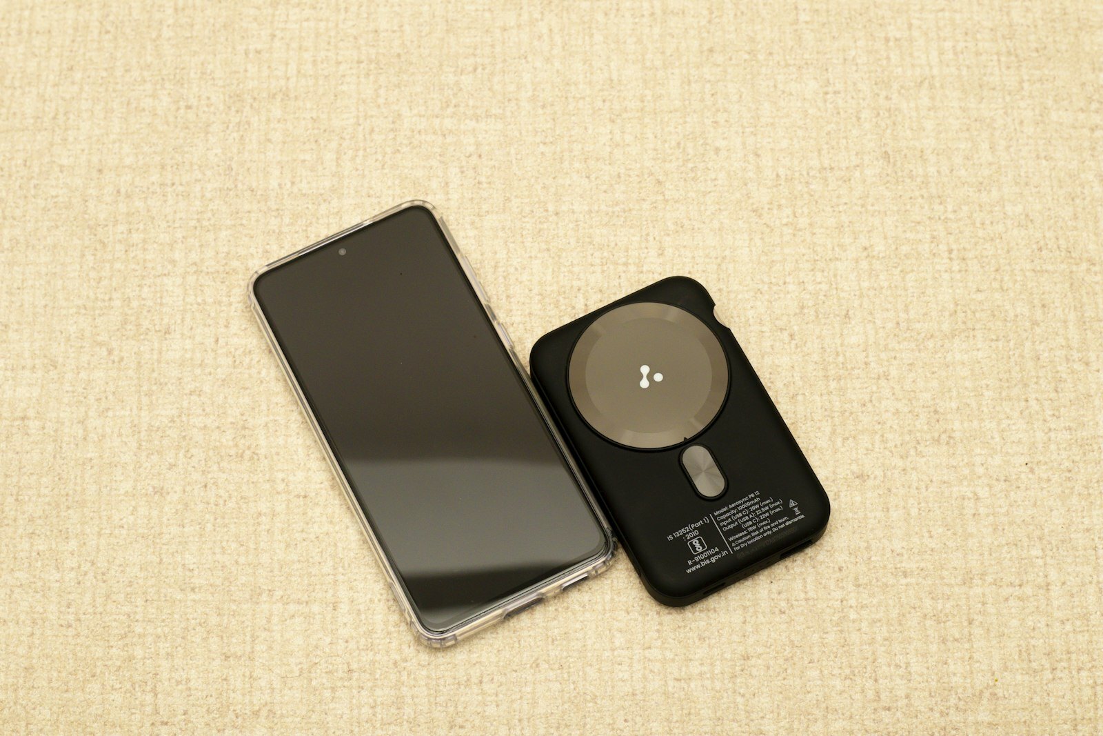 Smartphone and wireless charger on a textured surface